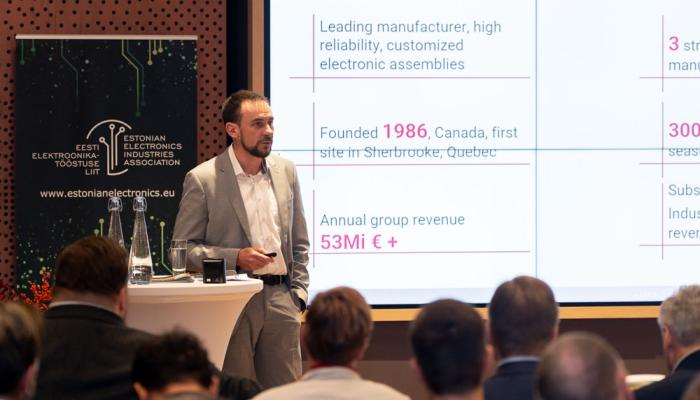 Speaker Riwan Tamic introducing electronics solutions manufacturer C-MAC's facts and figures.